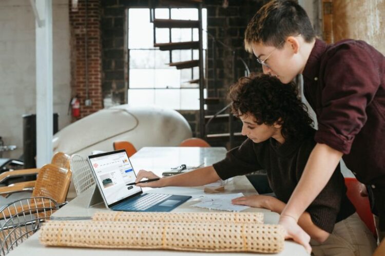 Small Businesses - a man and a woman are looking at a laptop