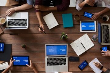 Business Meeting - Top View Photo Of People Near Wooden Table