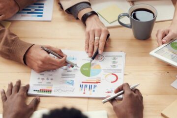 Business Meeting - People Discuss About Graphs and Rates