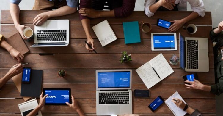 Business Meeting - Top View Photo Of People Near Wooden Table