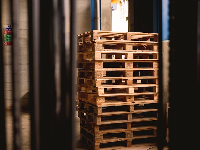 selective-focus-photography-of-piled-brown-wooden-pallets